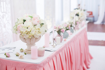 Wedding ceremony decoration in the restaurant. Decoration of wedding table with tender pink textile
