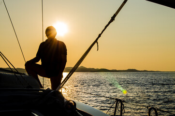 Backlight silhouette portrait on the sailboat in Croatia
