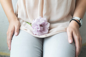 Woman holding elegant purple rose in her hand.