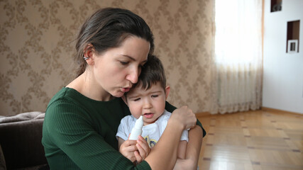Mom soothes her little upset son. Love of family concept