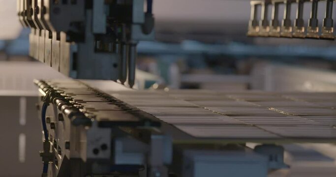 Solar cell stringer soldering ribbons on cells, close-up