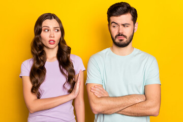 Fototapeta premium Portrait of attractive annoyed mad couple having fight misunderstanding isolated over bright yellow color background