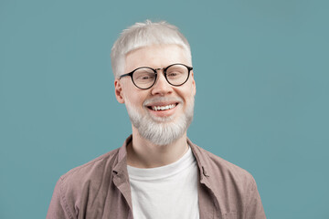 Headshot portrait of happy man with pale skin wearing eyeglasses, looking and smiling at camera on...