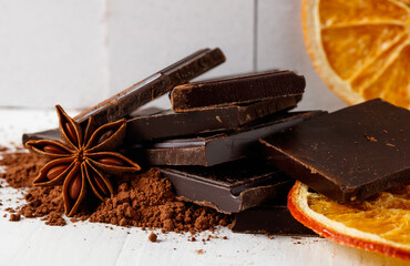 broken dark chocolate, cocoa, and dried orange wedges
