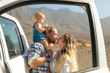 Beautiful portrait of a young family having a road trip with their baby