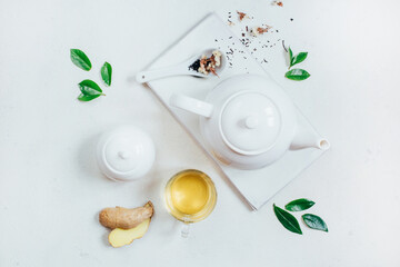 Fototapeta na wymiar top view of a set of tea utensils teapot sugar bowl cup with tea on a white background