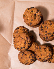 Cookies with chocolate icing, on gray packaging paper, copy space, template