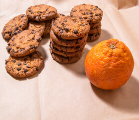 Cookies with chocolate icing orange, on gray packaging paper, copy space, template