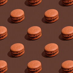Seamless pattern of brown chocolate macaroons on brown background. Sweet And Colourful French cookies Macaroons. Sweet background, concept.