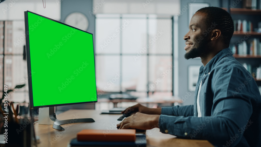 Poster handsome black african american specialist working on desktop computer with green screen mock up dis