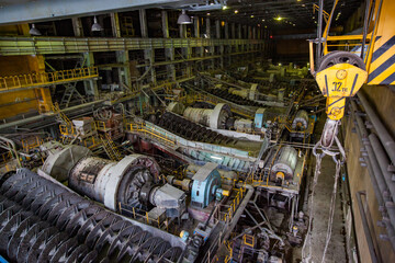 Stepnogorsk, Kazakhstan - April 04, 2012: Mining and processing plant.  Mill factory workshop. Ball mills and yellow crane hook.