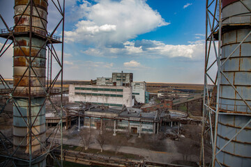Outdated Soviet mining and processing plant. Smoke stacks and industrial building.