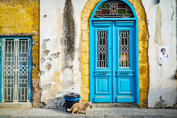 Facade of typical Cypriot house with shabby ruin windows and doors in town of Nicosia , Cyprus - obrazy, fototapety, plakaty