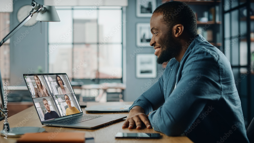 Aufkleber handsome african american man having a video call on laptop computer while sitting behind desk in li