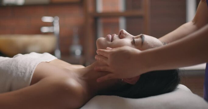 Close up of head massage of beautiful woman with feeling relaxation. Slow motion