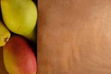 Ripe pears on a copper surface. Copy space. 
