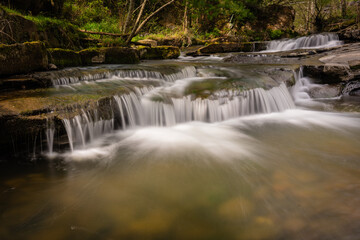 Fototapeta na wymiar Small waterfalls in a river 