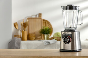 Blender in the kitchen on a wooden table in a beautiful interior and soak up the sun 