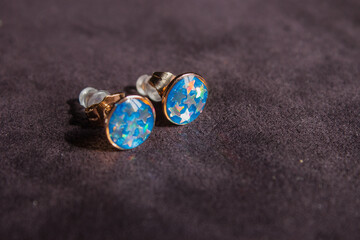 blue sapphire round shape stud yellow gold prong set earrings on white background