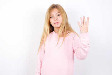 Beautiful caucasian blonde little girl wearing pink sweater smiling and looking friendly, showing number four or fourth with hand forward, counting down