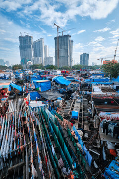 Dhobi Ghat Mahalaxmi Dhobi Ghat is an open air laundromat lavoir in Mumbai, India with laundry drying on ropes