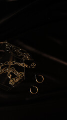 Dark brown background with gold accessories in jewelry box