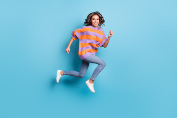 Fototapeta na wymiar Full length body size view of charming active cheerful girl jumping running isolated over bright blue color background