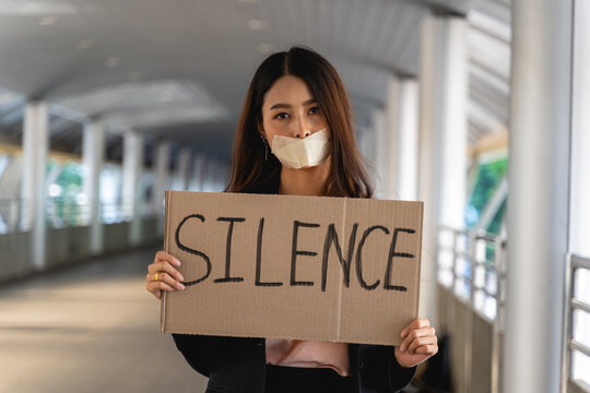 Asian woman activists with banners protesting to democracy and equality. Men and women doing a silent protest for democracy and equality