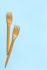 Disposable plastic forks on a blue background. Disposable tableware. Concept. Place for your text. High quality photo