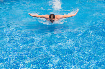 Obraz na płótnie Canvas Competitive Swimmer training butterfly style