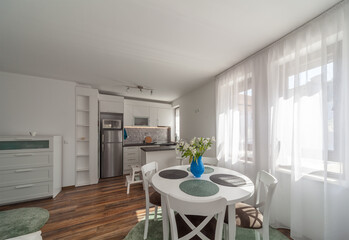 New modern living room with kitchen. New home. Interior photography. Wooden floor.