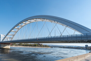 Concrete construction of a new bridge with arches above the water Novi Sad, Serbia