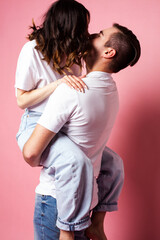 young cheerful caucasian couple together having fun on pink background, guy ang girl modern relationship, lifestyle people concept