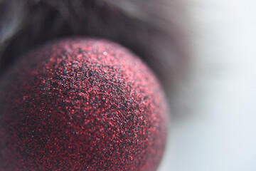 selective focus at the red ball with glitters on the surface