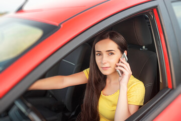Woman talking on the phone while driving a car.
