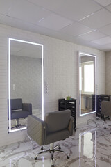 Fototapeta na wymiar barber chair and mirrors in an elite beauty salon, cosmetologist's office interior