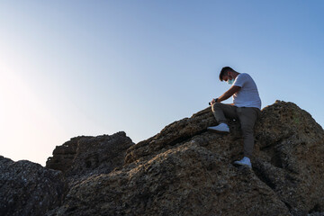 Obraz premium shot of a white Caucasian man walking on the rocks