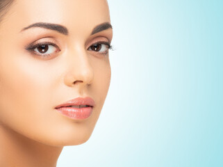 Fototapeta premium Beautiful face of young and healthy woman. Spa, cosmetology and healthcare.