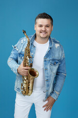 Fototapeta premium musician man with the saxophone on studio background.