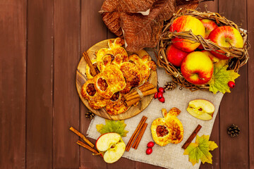 Homemade apple dessert, portioned puffs with fragrant cinnamon sticks, colorful foliage, autumn good mood