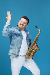 musician man with the saxophone on studio background.