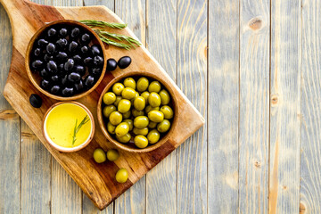 Set of green and black olives with oil in bowls. Top view