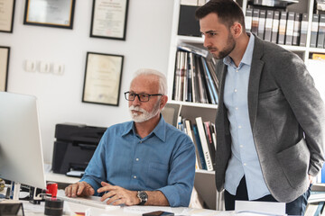 Young assistant explaining to his manager how to solve the problem.Working day at the office.