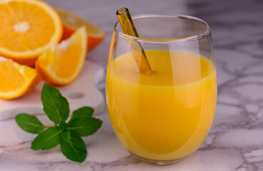 A glass of fresh orange juice on a slab.
Close-up.