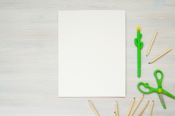 Blank white paper for design or text presentation, children activity sheet, coloring page, stationery, planner mockup,  back to school, creativity, education concept, wooden pencils, scissors.