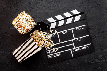 Fototapeta na wymiar Film reel with popcorn and clapperboard. Cinema concept