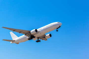 Fototapeta na wymiar Passenger airplane flying against clear blue sky