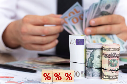 Interest rate finance and mortgage rates concept. businessman budget and loan calculation. dollar and euro money economy concept.
