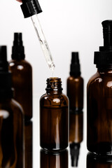 Face skin and body care concept, Healthy natural cosmetics in dark glass reusable bottles. Hyaluronic acid with pipette.