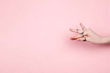 Woman hand showing hasta of indian classical dance. Caucasian female hands wearing silver rings. Meditation and self healing concept